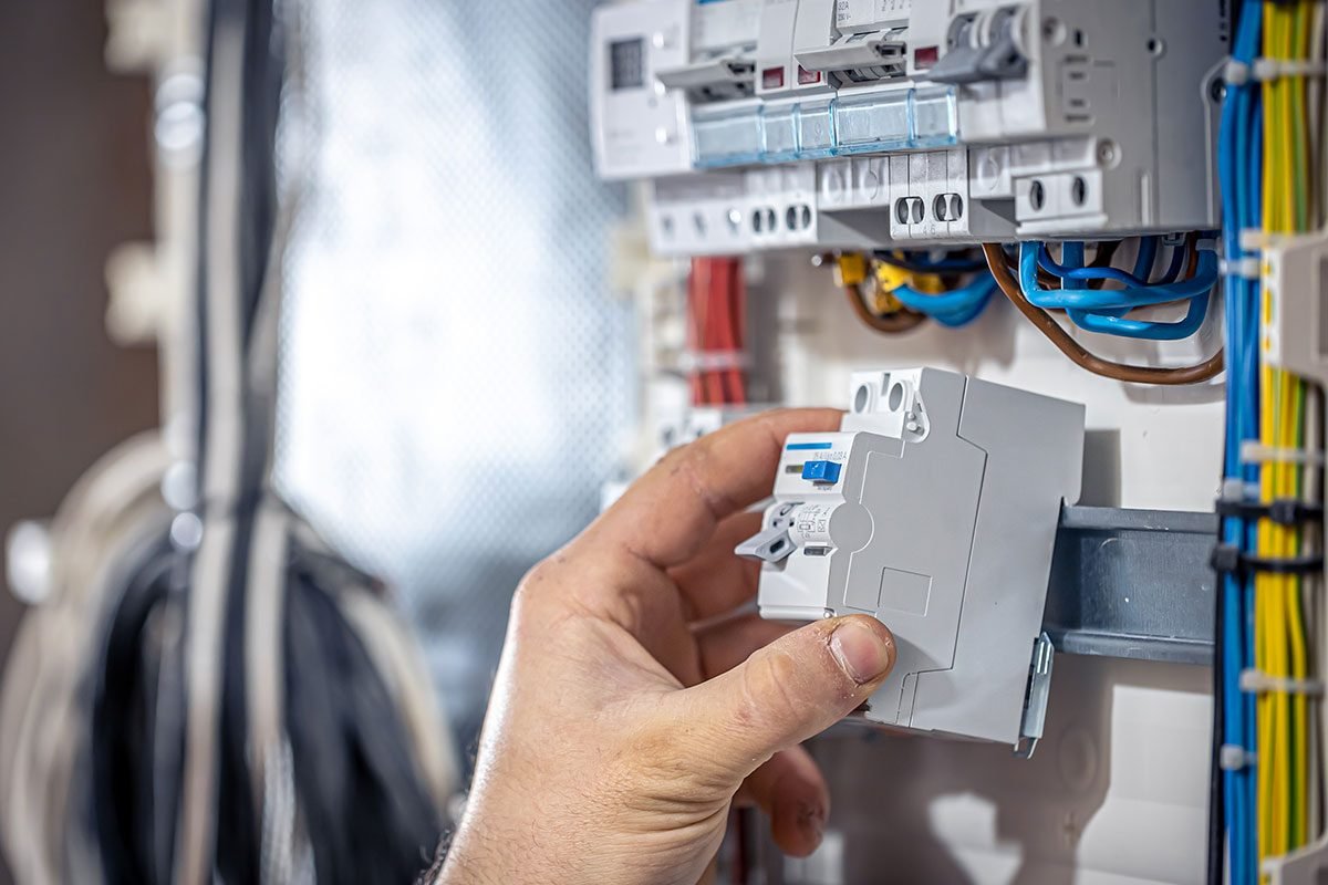 Electricista instalando un breaker en el tablero eléctrico